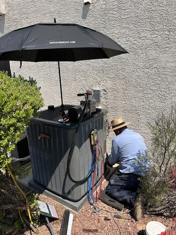 HVAC technician performing outdoor AC maintenance in Oceola
